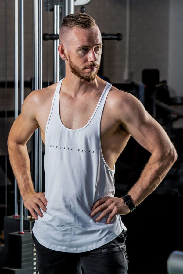 Male wearing white YNF singlet