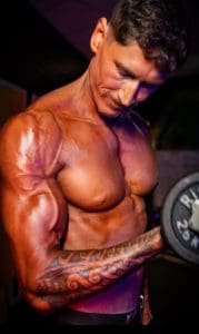Bodybuilder flexing with barbell